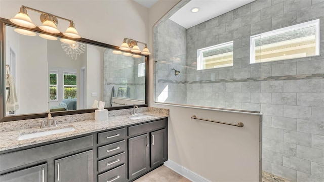 11825 Frost Aster Dr, Riverview, FL 33579 - ensuite bathroom featuring double vanity, a walk in shower, and a chandelier