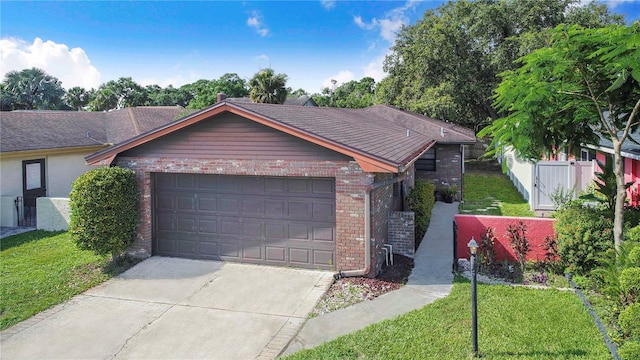 1523 Mariner Rd, Lakeland, FL 33803 - single story home with brick siding, an attached garage, and driveway