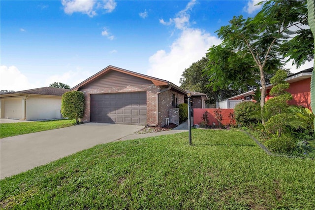 1523 Mariner Rd, Lakeland, FL 33803 - single story home with brick siding, concrete driveway, and an attached garage