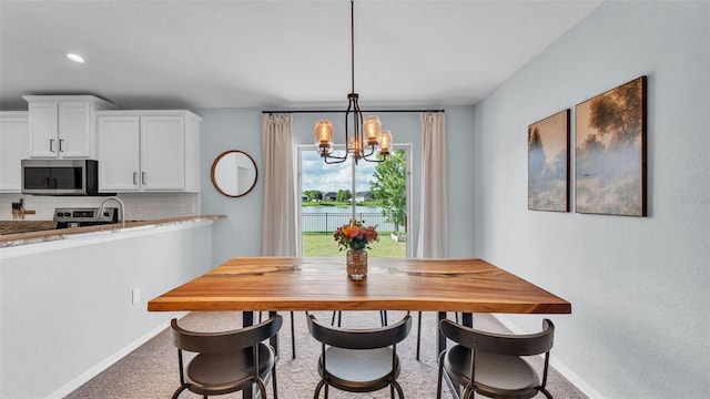 3739 Peregrine Way, Lakeland, FL 33811 - dining area featuring carpet and a chandelier