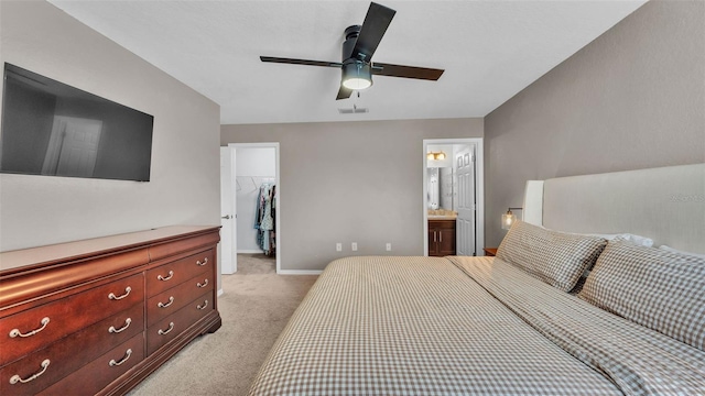 3739 Peregrine Way, Lakeland, FL 33811 - bedroom with light carpet, a spacious closet, a closet, ceiling fan, and ensuite bathroom