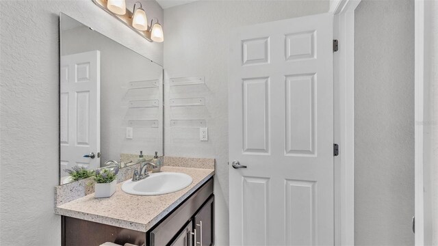 3739 Peregrine Way, Lakeland, FL 33811 - bathroom featuring vanity and a textured wall