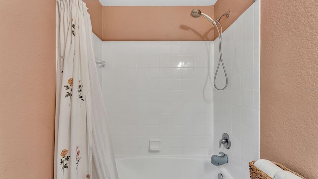 3739 Peregrine Way, Lakeland, FL 33811 - bathroom with a textured wall and shower / tub combo with curtain