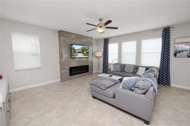1044 Oliveto Verdi Ct, Brandon, FL 33511 - living room with a ceiling fan, light tile patterned floors, and a fireplace