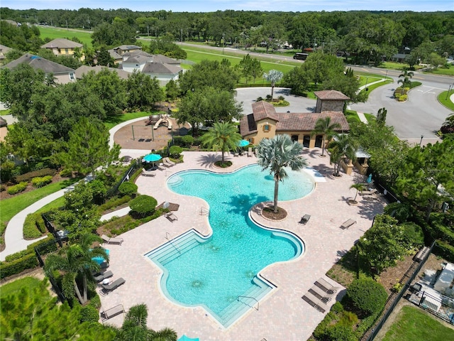 1044 Oliveto Verdi Ct, Brandon, FL 33511 - community pool featuring a patio area and view of wooded area