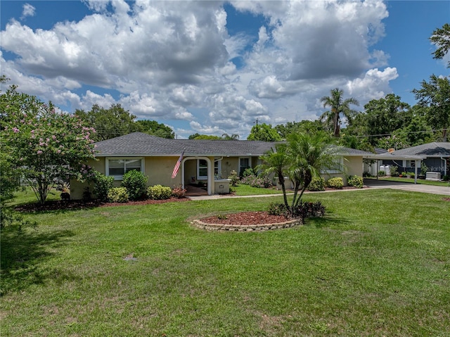 1232 Fairlee St, Lakeland, FL 33813 - ranch-style home with stucco siding, concrete driveway, a carport, and a front lawn