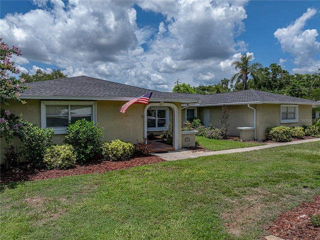 1232 Fairlee St, Lakeland, FL 33813 - ranch-style house with stucco siding, a front yard, and a shingled roof