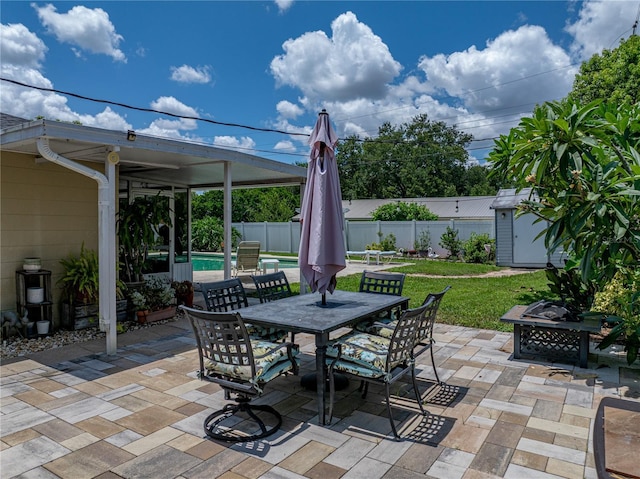 1232 Fairlee St, Lakeland, FL 33813 - fenced backyard with a storage unit, outdoor dining space, a patio area, and an outdoor fire pit