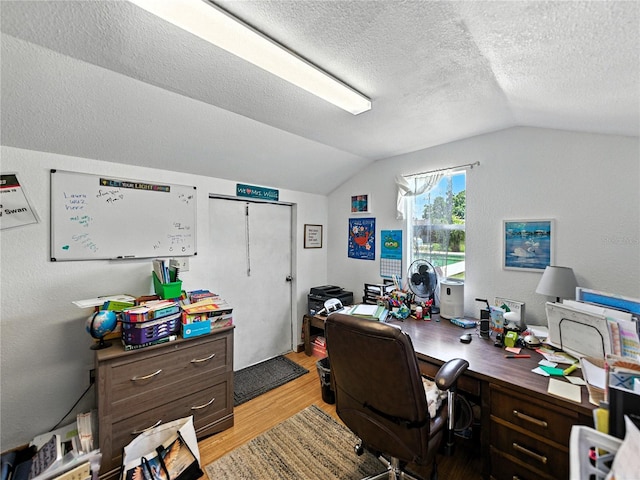 1232 Fairlee St, Lakeland, FL 33813 - home office with light wood-style flooring, vaulted ceiling, and a textured ceiling