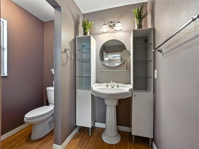 1232 Fairlee St, Lakeland, FL 33813 - bathroom featuring wood finished floors and toilet