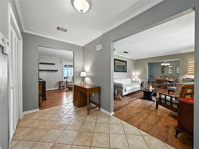 1232 Fairlee St, Lakeland, FL 33813 - living area featuring light tile patterned floors, crown molding, and a chandelier