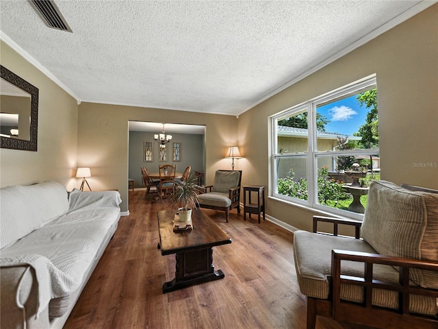 1232 Fairlee St, Lakeland, FL 33813 - living area featuring crown molding, wood finished floors, a textured ceiling, and a chandelier