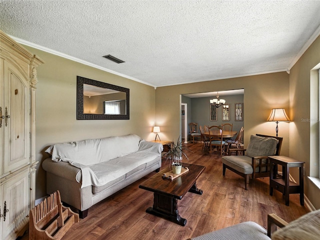 1232 Fairlee St, Lakeland, FL 33813 - living room featuring a chandelier, wood finished floors, a textured ceiling, and ornamental molding