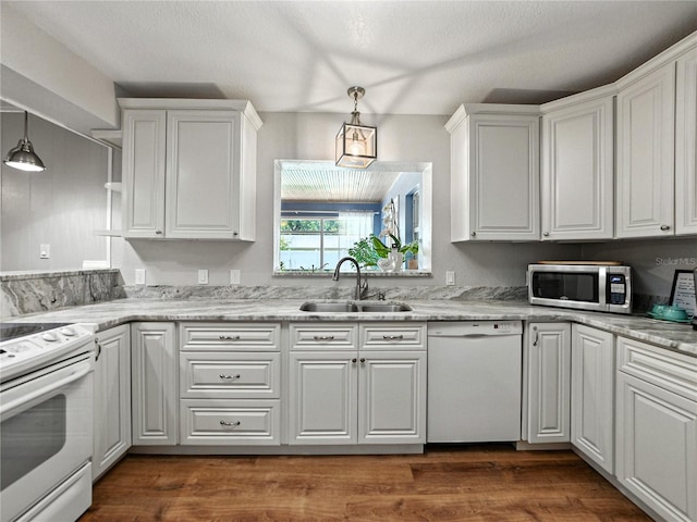 1232 Fairlee St, Lakeland, FL 33813 - kitchen with white appliances, white cabinets, pendant lighting, and dark wood finished floors