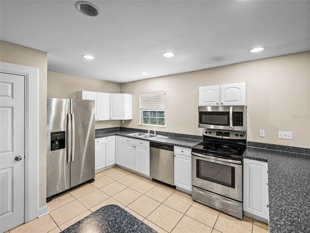 4230 Viola Rd, Lakeland, FL 33810 - kitchen with appliances with stainless steel finishes, dark countertops, white cabinetry, recessed lighting, and light tile patterned flooring