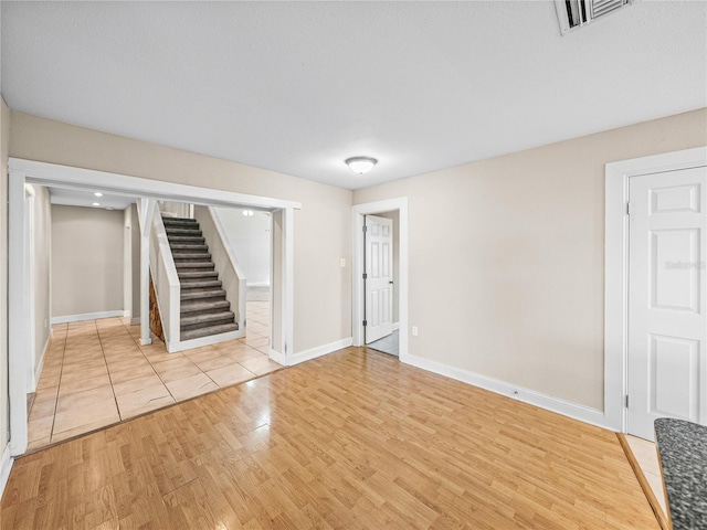 4230 Viola Rd, Lakeland, FL 33810 - empty room with stairway and light wood-style floors