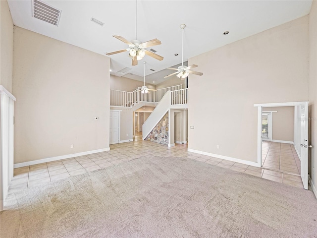 4230 Viola Rd, Lakeland, FL 33810 - unfurnished living room featuring tile patterned flooring, a towering ceiling, stairway, ceiling fan, and recessed lighting