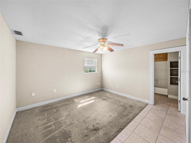 4230 Viola Rd, Lakeland, FL 33810 - empty room with a ceiling fan, light tile patterned floors, and light colored carpet