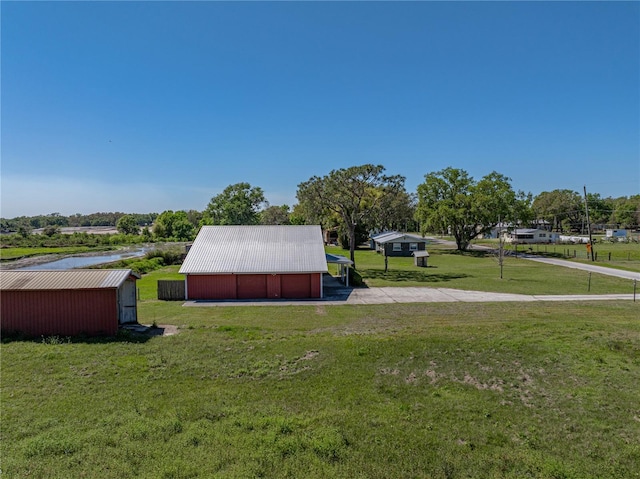 4230 Viola Rd, Lakeland, FL 33810 - view of green lawn featuring driveway, an outbuilding, and a garage