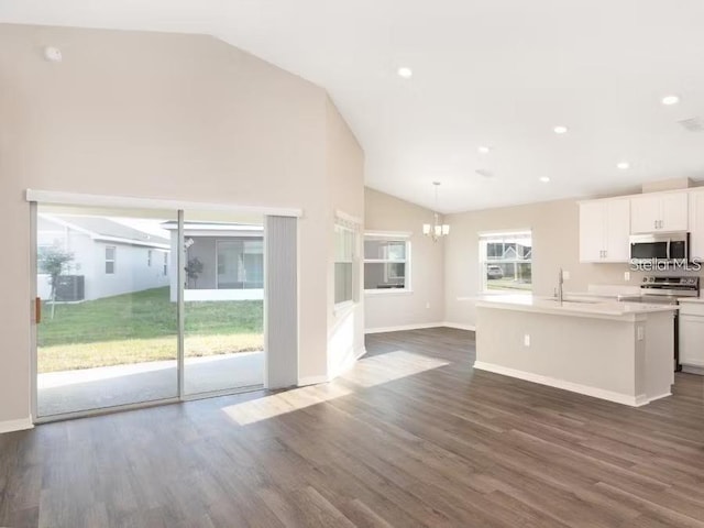 2572 58th Cir E, Palmetto, FL 34221 - kitchen with stainless steel microwave, lofted ceiling, stove, a chandelier, and an island with sink