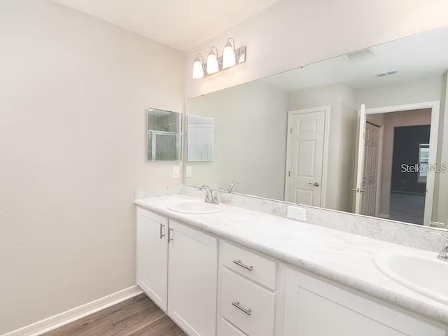 2572 58th Cir E, Palmetto, FL 34221 - full bathroom with double vanity and wood finished floors
