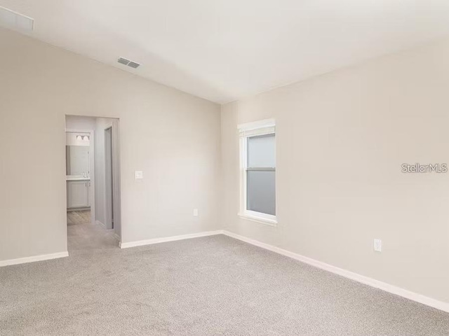 2572 58th Cir E, Palmetto, FL 34221 - carpeted empty room with baseboards and vaulted ceiling