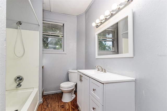 121 F Ave SW, Winter Haven, FL 33880 - full bath featuring vanity, healthy amount of natural light, wood finished floors, and shower / bath combination