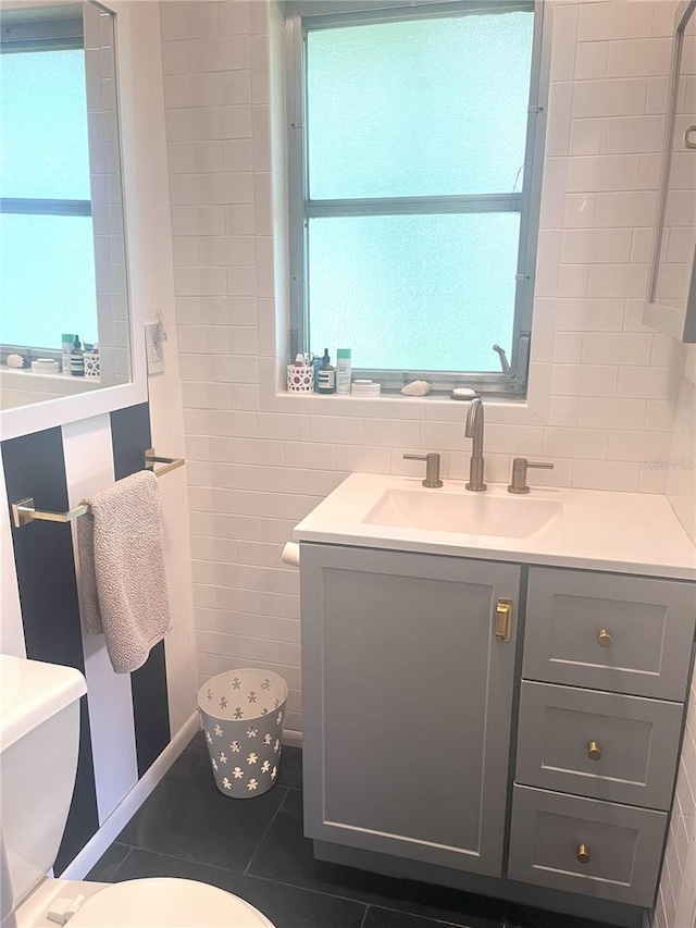 4718 Crystal Ave, Sarasota, FL 34231 - half bathroom featuring vanity, tile walls, and tile patterned floors