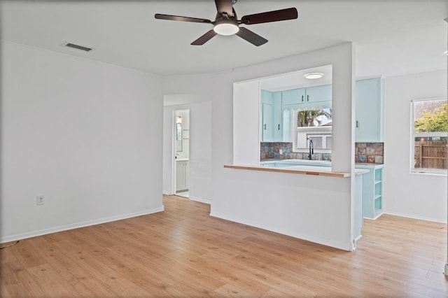275 Garden Rd, Venice, FL 34293 - unfurnished living room featuring ceiling fan and light wood-style flooring