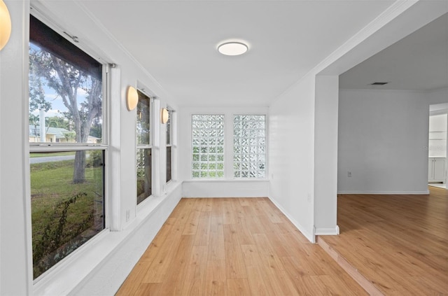 275 Garden Rd, Venice, FL 34293 - unfurnished sunroom featuring wood finished floors and ornamental molding