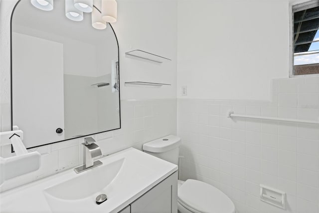 275 Garden Rd, Venice, FL 34293 - bathroom with tile walls, vanity, and a wainscoted wall