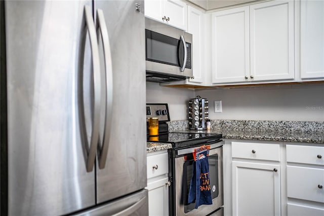3542 Raintree Ct, Lakeland, FL 33803 - kitchen featuring stainless steel appliances, white cabinets, and light stone counters