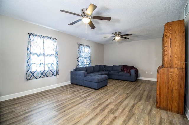 3542 Raintree Ct, Lakeland, FL 33803 - living room featuring wood finished floors, ceiling fan, and a textured ceiling