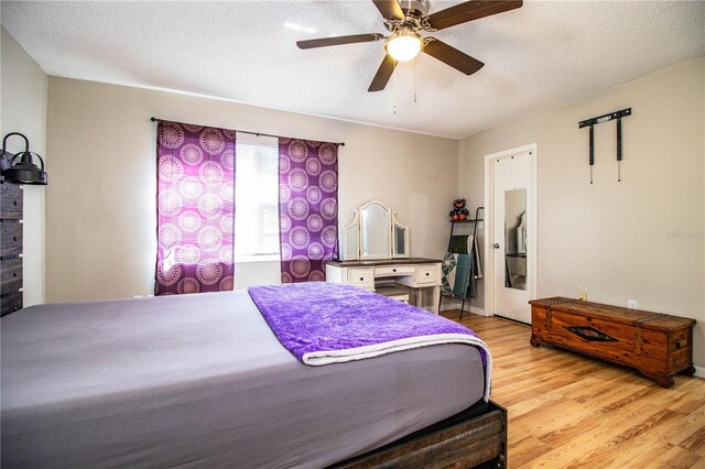 3542 Raintree Ct, Lakeland, FL 33803 - bedroom with light wood-style flooring, a textured ceiling, and a ceiling fan
