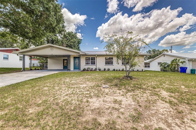 508 Boger Blvd N, Lakeland, FL 33803 - ranch-style house featuring concrete driveway, a carport, a front yard, and a metal roof