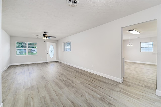 508 Boger Blvd N, Lakeland, FL 33803 - unfurnished living room with ceiling fan, light wood-type flooring, and a textured ceiling