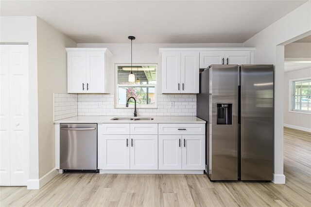 508 Boger Blvd N, Lakeland, FL 33803 - kitchen featuring stainless steel appliances, light wood-type flooring, light countertops, and white cabinetry