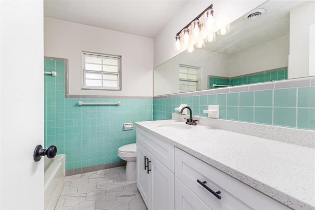 508 Boger Blvd N, Lakeland, FL 33803 - bathroom with tile walls, vanity, tile patterned flooring, and shower / tub combination