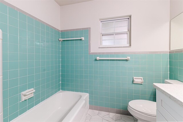 508 Boger Blvd N, Lakeland, FL 33803 - bathroom featuring vanity, tile walls, bathtub / shower combination, and a wainscoted wall