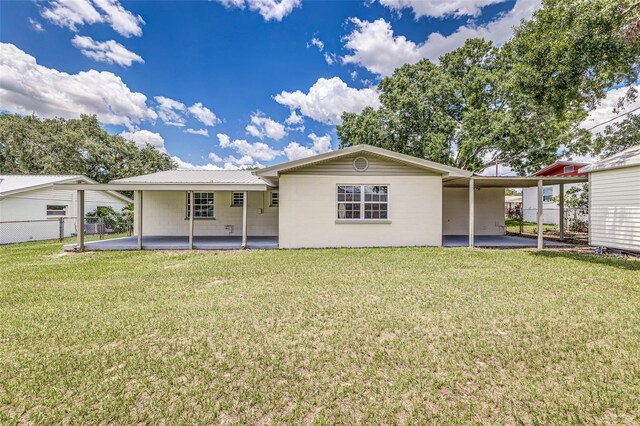 508 Boger Blvd N, Lakeland, FL 33803 - back of house with an attached carport, a patio area, and a metal roof