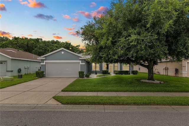 4242 Whistlewood Cir, Lakeland, FL 33811 - view of front of property with an attached garage, a front yard, driveway, and stucco siding