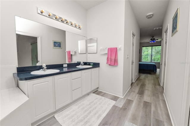 4242 Whistlewood Cir, Lakeland, FL 33811 - bathroom with double vanity, wood finished floors, and connected bathroom