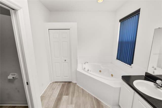 4242 Whistlewood Cir, Lakeland, FL 33811 - full bathroom featuring a whirlpool tub, vanity, and wood finished floors