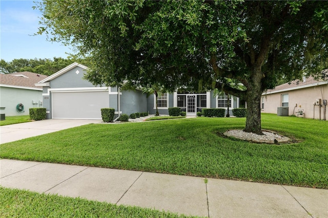 4242 Whistlewood Cir, Lakeland, FL 33811 - view of front of house featuring an attached garage, concrete driveway, a front yard, and stucco siding