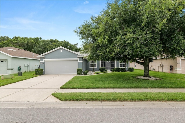4242 Whistlewood Cir, Lakeland, FL 33811 - ranch-style house with an attached garage, driveway, a front yard, and stucco siding