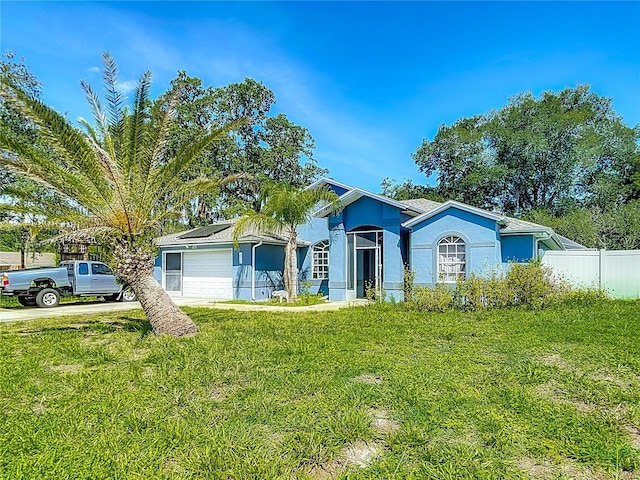 173 Portland Ave, Spring Hill, FL 34606 - single story home featuring a garage, stucco siding, and solar panels
