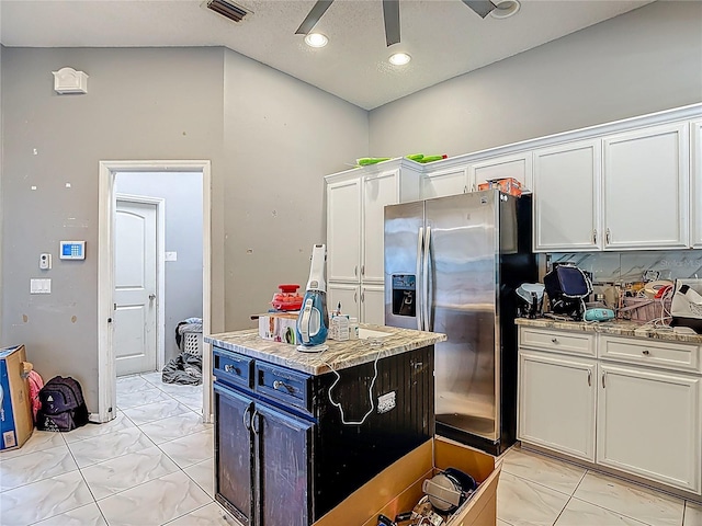 173 Portland Ave, Spring Hill, FL 34606 - kitchen featuring stainless steel refrigerator with ice dispenser, light marble finish floors, a ceiling fan, white cabinets, and light stone counters