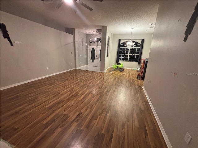 173 Portland Ave, Spring Hill, FL 34606 - unfurnished living room featuring washer and clothes dryer, wood finished floors, ceiling fan, a chandelier, and a textured ceiling