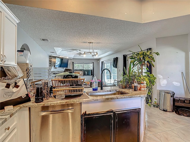 173 Portland Ave, Spring Hill, FL 34606 - kitchen with a textured ceiling, dishwasher, white cabinetry, open floor plan, and light marble finish flooring