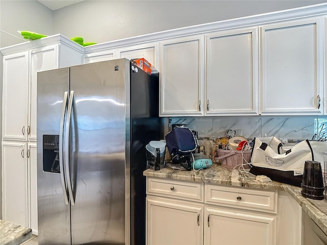 173 Portland Ave, Spring Hill, FL 34606 - kitchen featuring stainless steel fridge, white cabinetry, tasteful backsplash, and light stone countertops